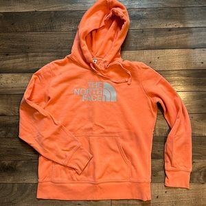 Coral colored North Face hoodie